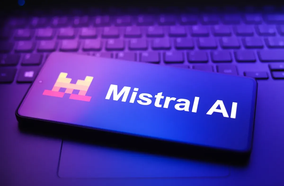 The Mistral AI company logo displayed prominently, with a blurred background of a modern office space, symbolizing innovation and growth in artificial intelligence.