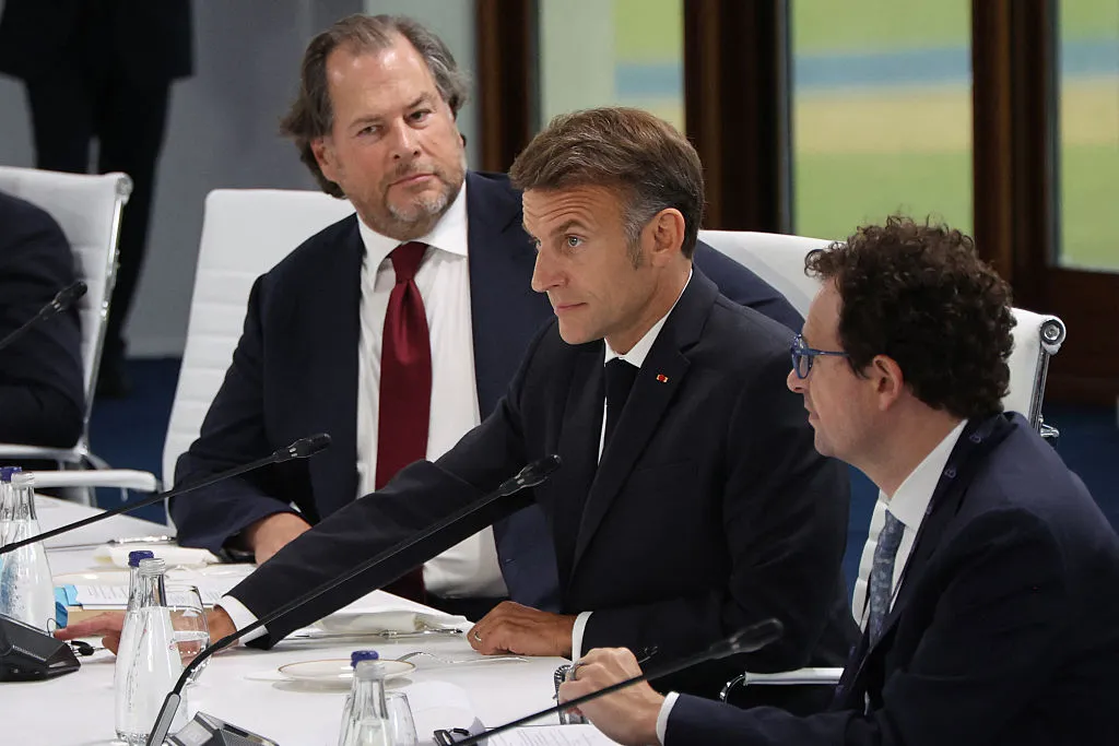 Indian Prime Minister Narendra Modi and French President Emmanuel Macron at the G7 Summit, engaged in discussions about AI policy and digital sovereignty.