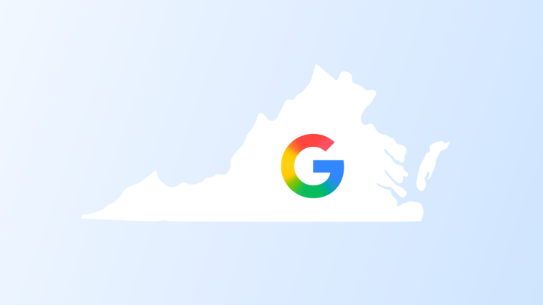 Exterior view of a modern Google data center in Virginia, featuring large solar panel installations on the surrounding grounds, under a clear sky.