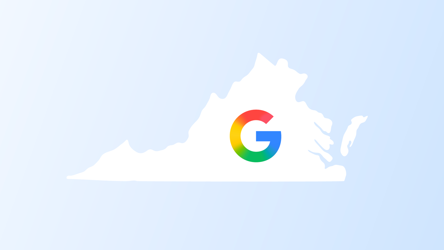 Exterior view of a modern Google data center in Virginia, featuring large solar panel installations on the surrounding grounds, under a clear sky.