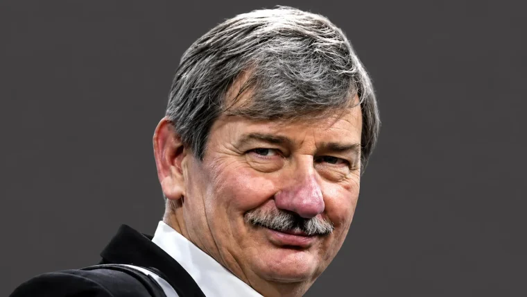 Portrait of Bruce Clay, a renowned SEO pioneer, speaking at a digital marketing conference, with a warm expression.