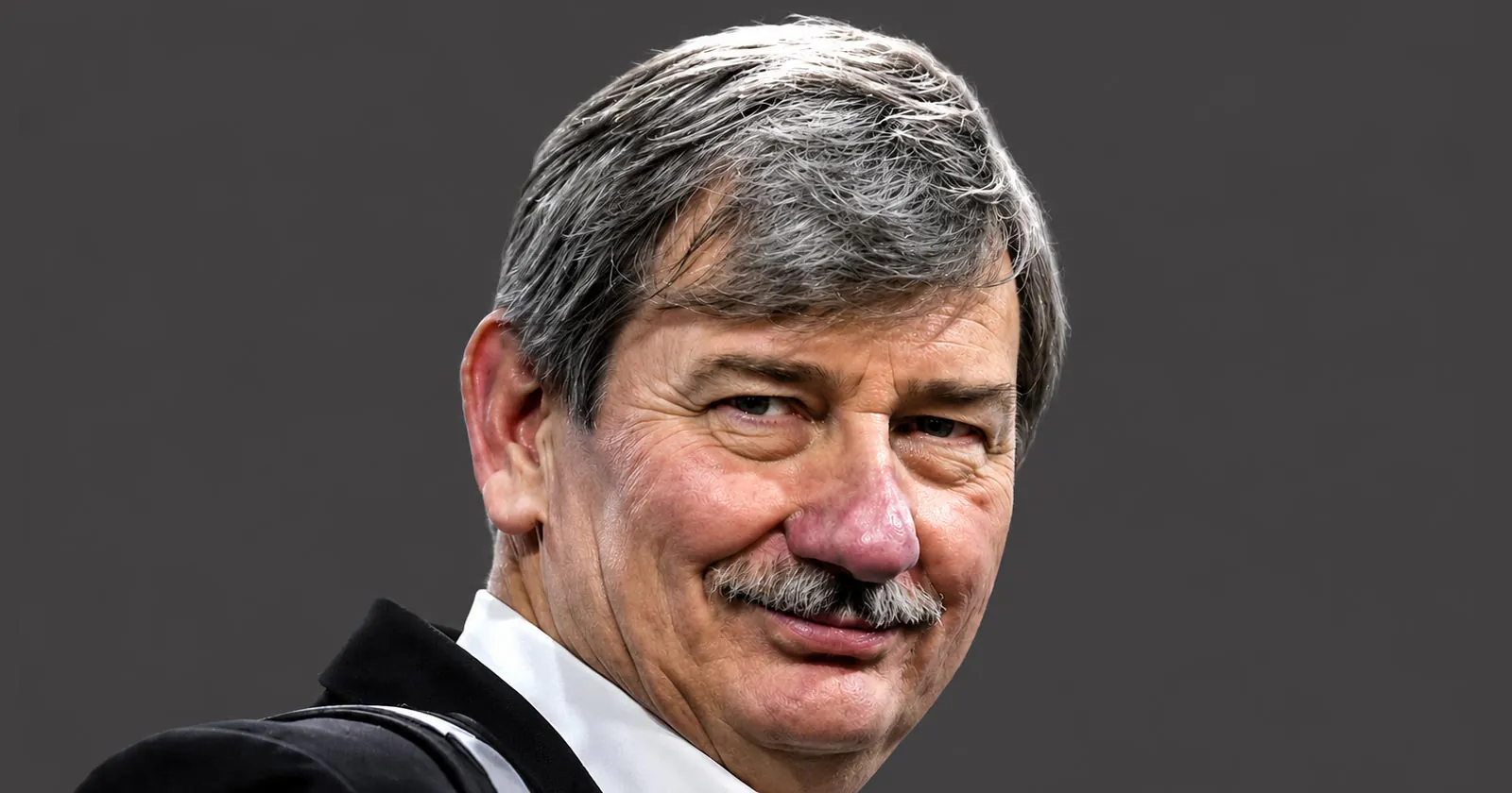 Portrait of Bruce Clay, a renowned SEO pioneer, speaking at a digital marketing conference, with a warm expression.