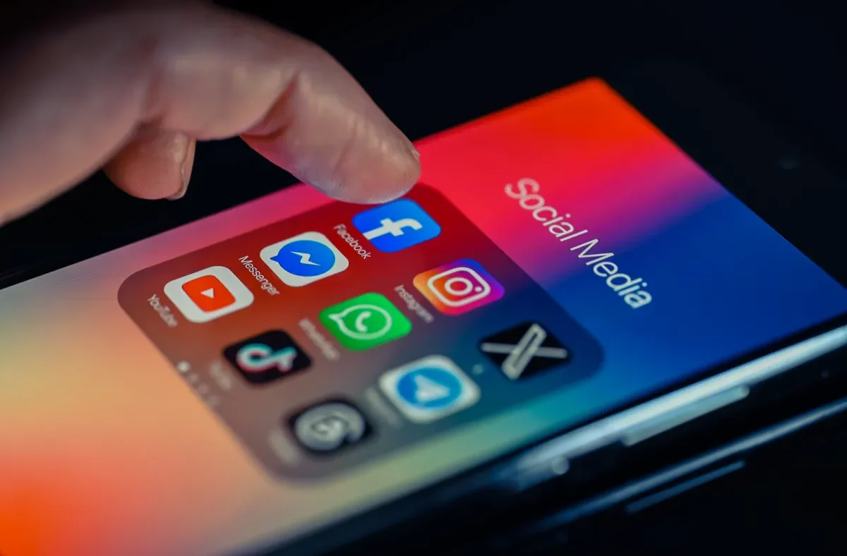 A user's hand holding a smartphone, with a social media feed displaying various content. Overlayed graphical elements suggest AI algorithms and personalization settings