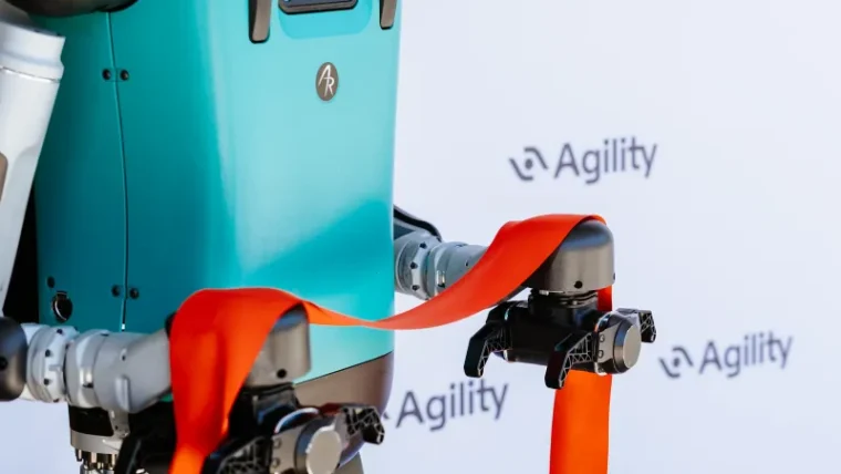 Agility Robotics' Digit humanoid robot moving totes in a warehouse