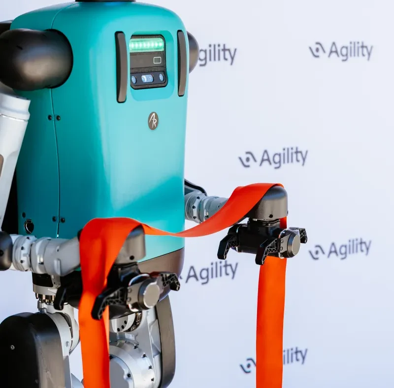Agility Robotics' Digit humanoid robot moving totes in a warehouse