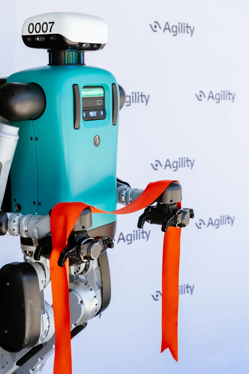Agility Robotics' Digit humanoid robot moving totes in a warehouse