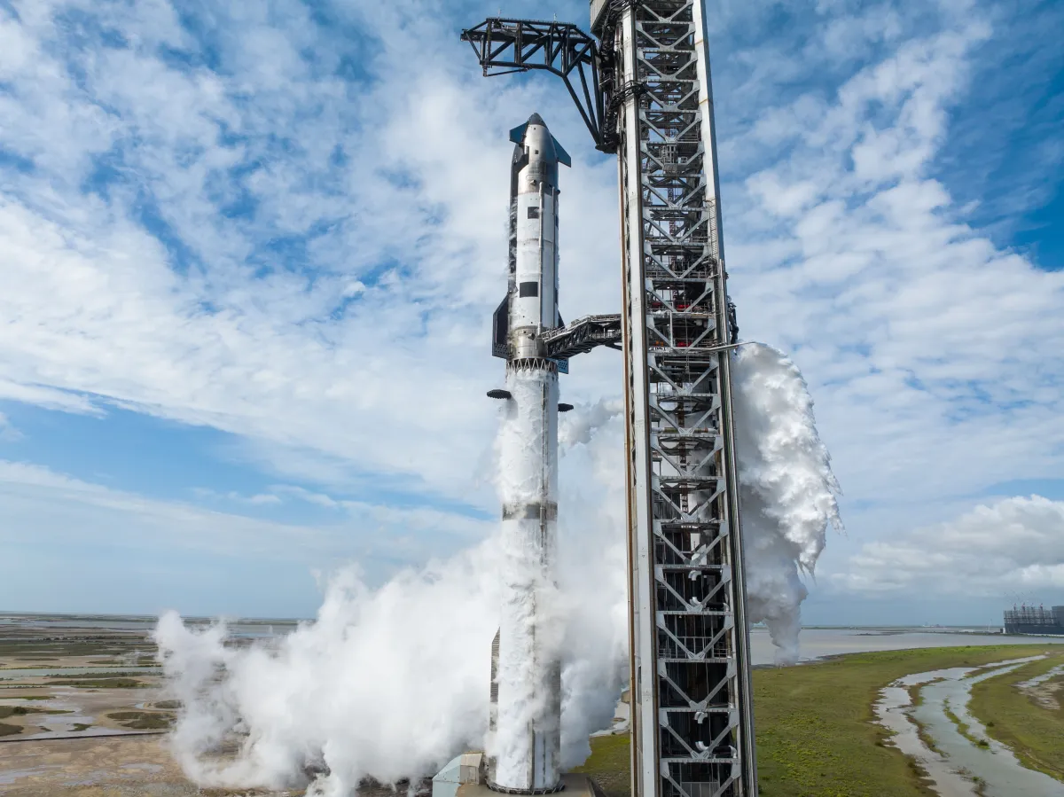 SpaceX Starship rocket on a launchpad with exhaust plumes