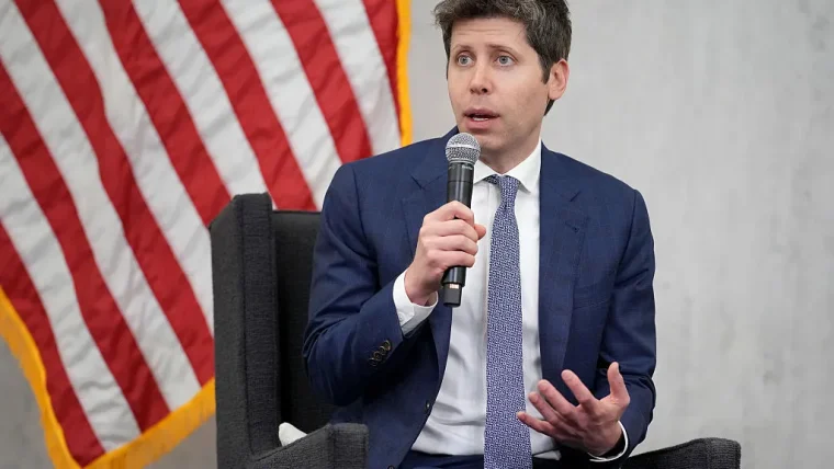 Sam Altman, CEO of OpenAI, speaking at a conference podium