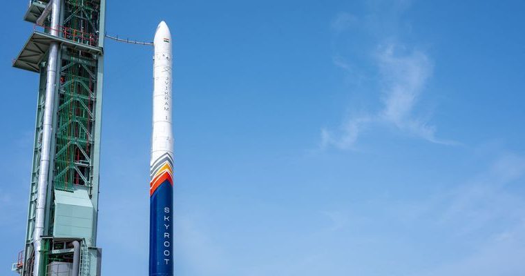 The Skyroot Vikram-1 rocket lifting off from a launchpad, with smoke and fire trailing, against a clear sky.