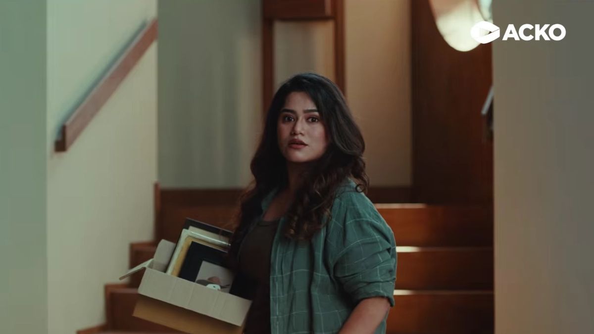 ACKO health insurance campaign film scene with creators Vishakha Biswas and Divesh Khatri opting for stairs