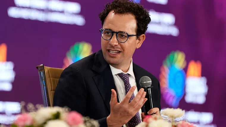 Anthropic CEO Dario Amodei speaking at a conference, discussing AI safety and frontier model regulation