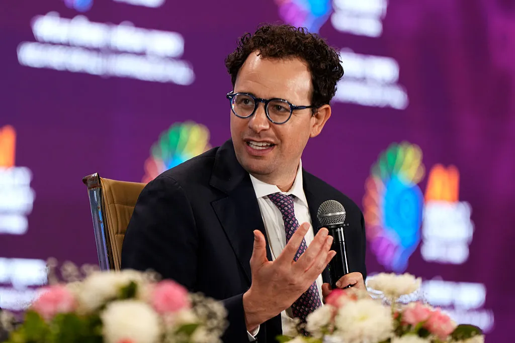 Anthropic CEO Dario Amodei speaking at a conference, discussing AI safety and frontier model regulation